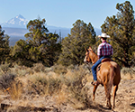 boy on horseback with mountian in the distance